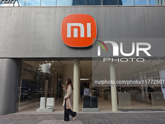 A pedestrian passes the Xiaomi store in Shanghai, China, on November 13, 2024. (