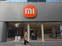 A pedestrian passes the Xiaomi store in Shanghai, China, on November 13, 2024. (