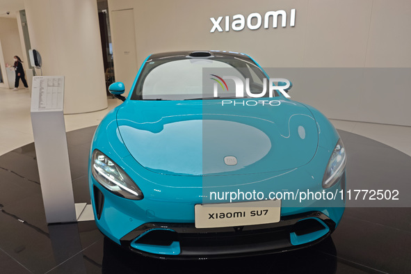 A Xiaomi SU7 car is displayed inside a Xiaomi store in Shanghai, China, on November 13, 2024. 