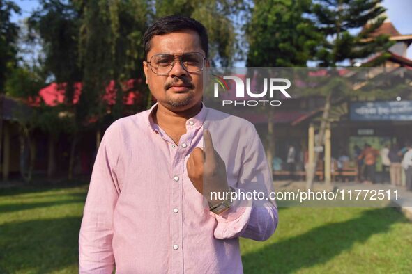 A voter shows his ink-marked finger after casting his ballot at a polling station during the Samaguri assembly constituency bypoll in Nagaon...