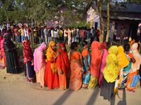 Voters wait in a queue at a polling station to cast votes during the Samaguri assembly constituency bypoll in Nagaon district, Assam, India,...