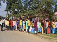 Voters wait in a queue at a polling station to cast votes during the Samaguri assembly constituency bypoll in Nagaon district, Assam, India,...