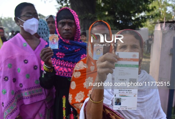 Voters wait in a queue at a polling station to cast votes during the Samaguri assembly constituency bypoll in Nagaon district, Assam, India,...