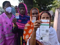 Voters wait in a queue at a polling station to cast votes during the Samaguri assembly constituency bypoll in Nagaon district, Assam, India,...