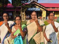 Voters show their ink-marked fingers after casting their ballots at a polling station during the Samaguri assembly constituency bypoll in Na...