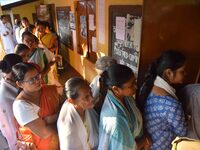 Voters wait in a queue at a polling station to cast votes during the Samaguri assembly constituency bypoll in Nagaon district, Assam, India,...