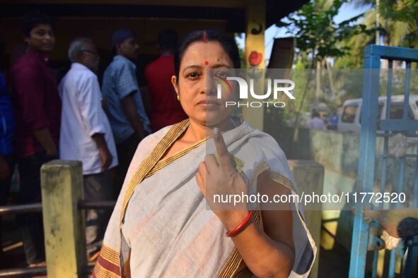 A voter shows her ink-marked finger after casting her ballot at a polling station during the Samaguri assembly constituency bypoll in Nagaon...