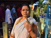 A voter shows her ink-marked finger after casting her ballot at a polling station during the Samaguri assembly constituency bypoll in Nagaon...