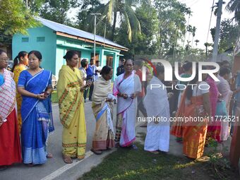 Voters wait in a queue at a polling station to cast votes during the Samaguri assembly constituency bypoll in Nagaon district, Assam, India,...