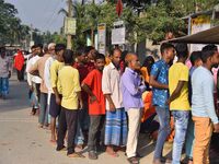 Voters wait in a queue at a polling station to cast votes during the Samaguri assembly constituency bypoll in Nagaon district, Assam, India,...