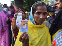 Voters wait in a queue at a polling station to cast votes during the Samaguri assembly constituency bypoll in Nagaon district, Assam, India,...