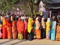 Voters wait in a queue at a polling station to cast votes during the Samaguri assembly constituency bypoll in Nagaon district, Assam, India,...