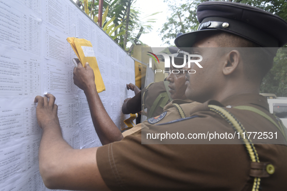 Sri Lankan police officers check their duties at the routing distribution center in Colombo, Sri Lanka, on November 13, 2024, a day before t...