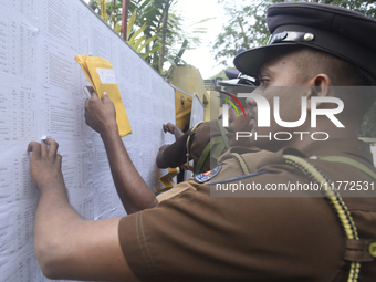 Sri Lankan police officers check their duties at the routing distribution center in Colombo, Sri Lanka, on November 13, 2024, a day before t...