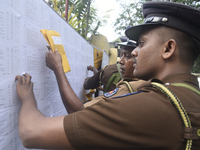 Sri Lankan police officers check their duties at the routing distribution center in Colombo, Sri Lanka, on November 13, 2024, a day before t...