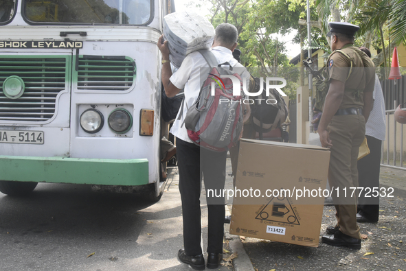 Polling officials carry election materials after collecting them from a distribution center in Colombo, Sri Lanka, on November 13, 2024, a d...