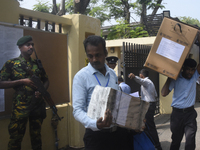 Polling officials carry election materials after collecting them from a distribution center in Colombo, Sri Lanka, on November 13, 2024, a d...