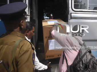 Polling officials carry election materials after collecting them from a distribution center in Colombo, Sri Lanka, on November 13, 2024, a d...