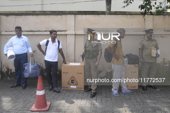 Polling officials carry election materials after collecting them from a distribution center in Colombo, Sri Lanka, on November 13, 2024, a d...