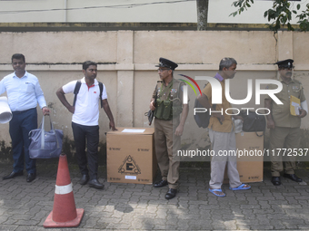 Polling officials carry election materials after collecting them from a distribution center in Colombo, Sri Lanka, on November 13, 2024, a d...