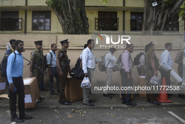 Polling officials carry election materials after collecting them from a distribution center in Colombo, Sri Lanka, on November 13, 2024, a d...