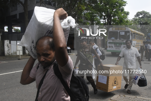 Polling officials carry election materials after collecting them from a distribution center in Colombo, Sri Lanka, on November 13, 2024, a d...