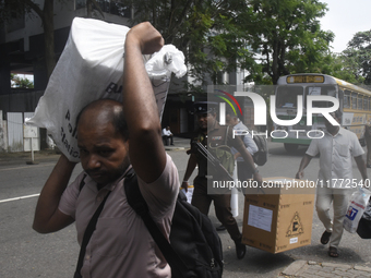 Polling officials carry election materials after collecting them from a distribution center in Colombo, Sri Lanka, on November 13, 2024, a d...