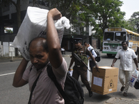 Polling officials carry election materials after collecting them from a distribution center in Colombo, Sri Lanka, on November 13, 2024, a d...