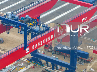 Workers work at the construction site of the third phase of the Canal new port operation zone in Huai'an City, East China's Jiangsu Province...