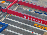 Workers work at the construction site of the third phase of the Canal new port operation zone in Huai'an City, East China's Jiangsu Province...