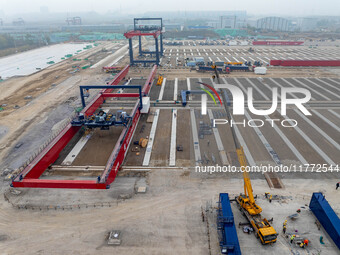 Workers work at the construction site of the third phase of the Canal new port operation zone in Huai'an City, East China's Jiangsu Province...