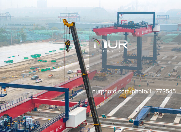 Workers work at the construction site of the third phase of the Canal new port operation zone in Huai'an City, East China's Jiangsu Province...