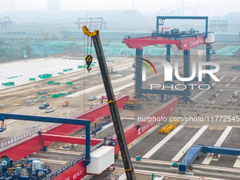 Workers work at the construction site of the third phase of the Canal new port operation zone in Huai'an City, East China's Jiangsu Province...