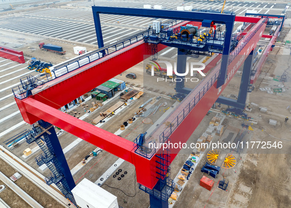 Workers work at the construction site of the third phase of the Canal new port operation zone in Huai'an City, East China's Jiangsu Province...