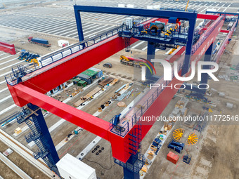 Workers work at the construction site of the third phase of the Canal new port operation zone in Huai'an City, East China's Jiangsu Province...