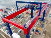 Workers work at the construction site of the third phase of the Canal new port operation zone in Huai'an City, East China's Jiangsu Province...