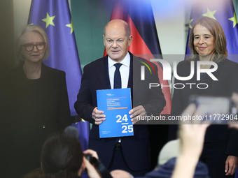 German Chancellor Olaf Scholz receives the Annual Report from the Council of Economic Experts at the Chancellery in Berlin, Germany, on Nove...