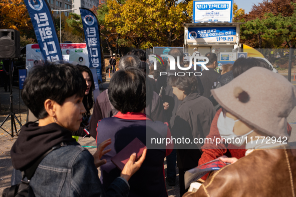 A crowd gathers in Yeouido Park, Seoul, South Korea, on November 13, 2024, to listen to Cho Kuk, leader of the Rebuilding Korea Party, as he...