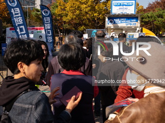 A crowd gathers in Yeouido Park, Seoul, South Korea, on November 13, 2024, to listen to Cho Kuk, leader of the Rebuilding Korea Party, as he...