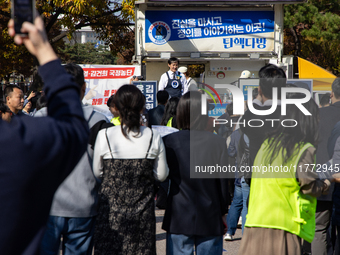 A crowd gathers in Yeouido Park, Seoul, South Korea, on November 13, 2024, to listen to Cho Kuk, leader of the Rebuilding Korea Party, as he...