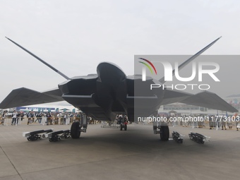 Visitors look at the ''BAIDI'' space fighter developed by Aviation Industry Corporation of China at the Zhuhai Air Show in Zhuhai, China, on...