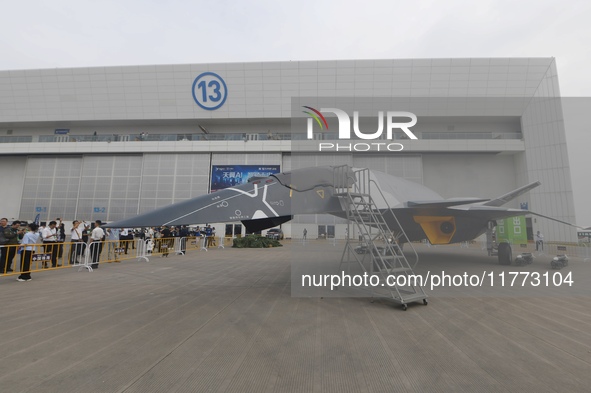 Visitors look at the ''BAIDI'' space fighter developed by Aviation Industry Corporation of China at the Zhuhai Air Show in Zhuhai, China, on...