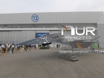 Visitors look at the ''BAIDI'' space fighter developed by Aviation Industry Corporation of China at the Zhuhai Air Show in Zhuhai, China, on...