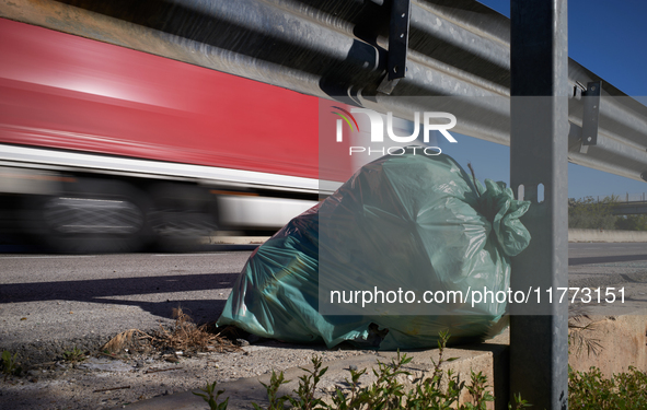 A large bag of mixed waste lies abandoned on a roadside rest area along State Highway 16 in San Ferdinando di Puglia, Italy, on October 3, 2...