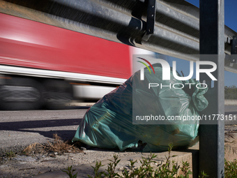 A large bag of mixed waste lies abandoned on a roadside rest area along State Highway 16 in San Ferdinando di Puglia, Italy, on October 3, 2...