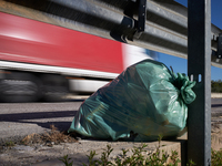 A large bag of mixed waste lies abandoned on a roadside rest area along State Highway 16 in San Ferdinando di Puglia, Italy, on October 3, 2...