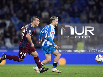 Hodei Arrillaga of SD Eibar competes for the ball with David Mella of RC Deportivo de La Coruna during the LaLiga Hypermotion match between...