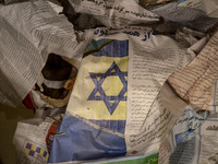 An Iranian newspaper featuring an Israeli flag is seen in a bin in Tehran, Iran, on October 31, 2024. (