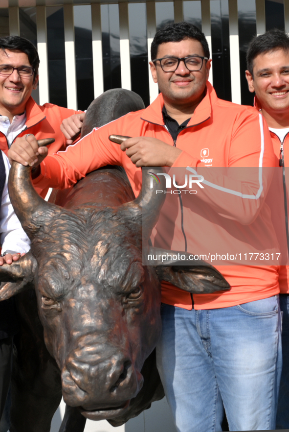 Managing Director and Group Chief Executive Officer of Swiggy, Sriharsha Majety, poses with the statue of the NSE bull ahead of the listing...