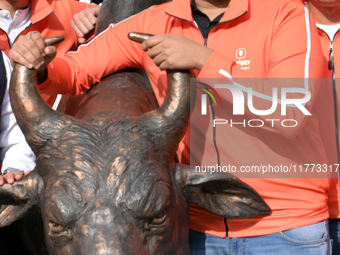 Managing Director and Group Chief Executive Officer of Swiggy, Sriharsha Majety, poses with the statue of the NSE bull ahead of the listing...